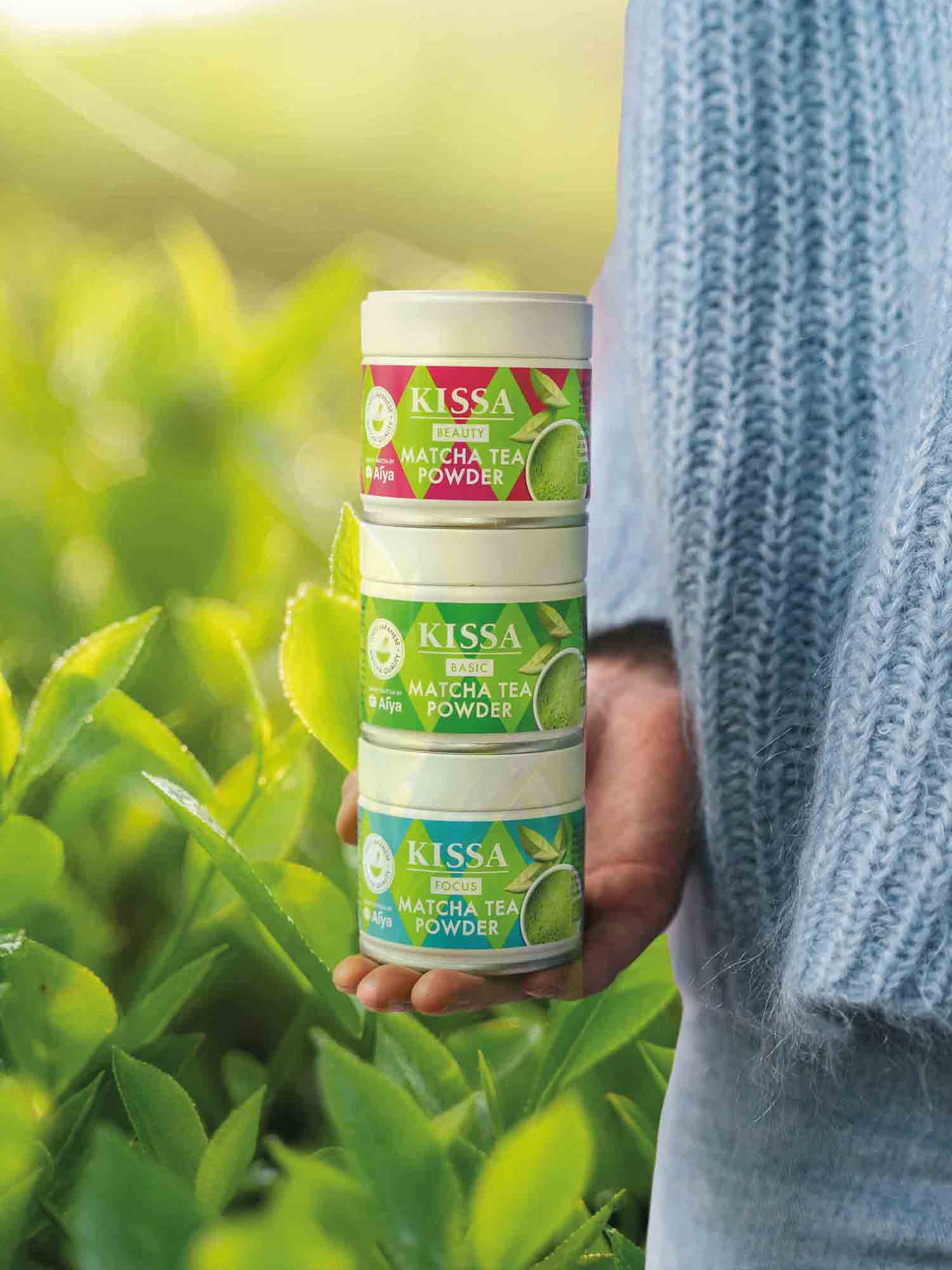 Woman holding three Kissa matcha products