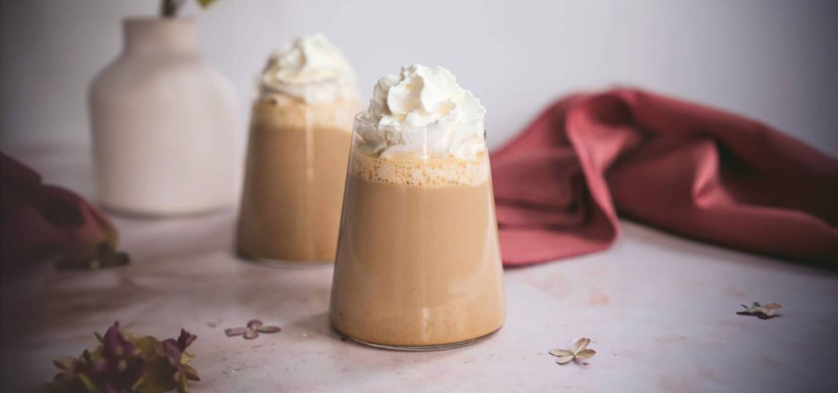Two chai lattes on a table