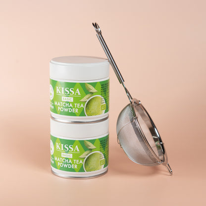 Two KISSA Matcha Basic tins next to a sieve