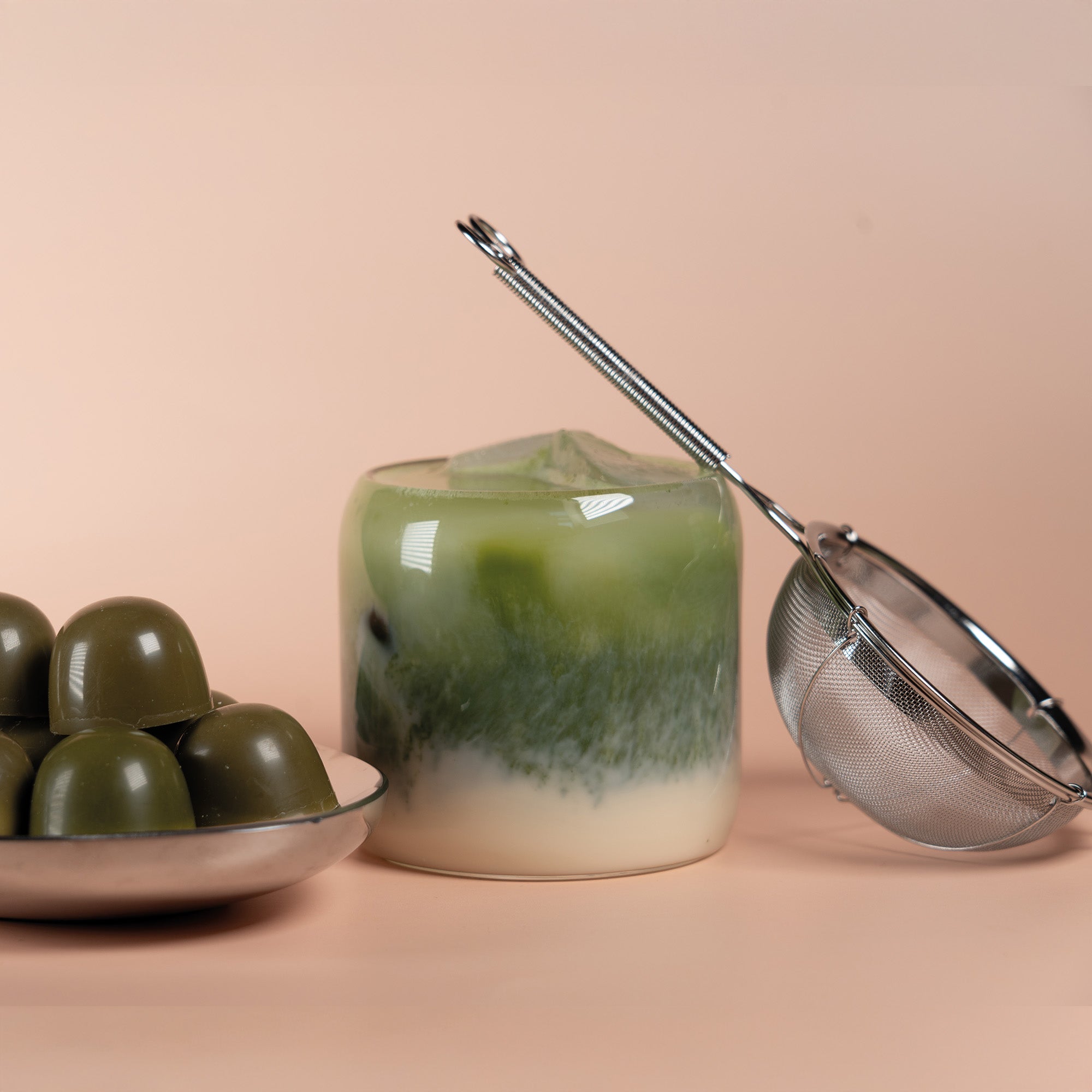 Matcha Latte, a sieve and Matcha Pralines