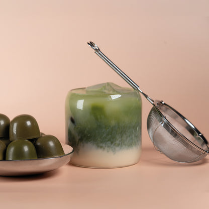 Matcha Latte, a sieve and Matcha Pralines